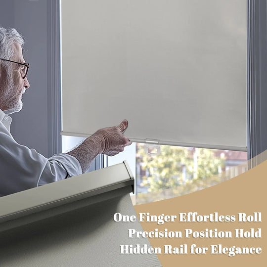 Person using hem handle on gray roller shade with gray bottom rail close-up inset