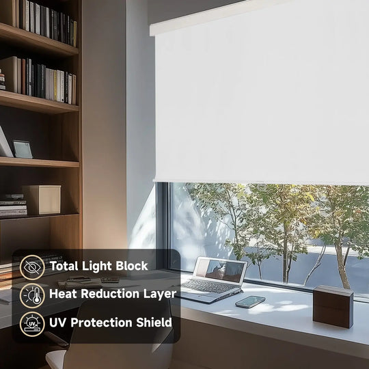 White blackout roller shade on home-office window beside laptop and bookcase with light-control labels